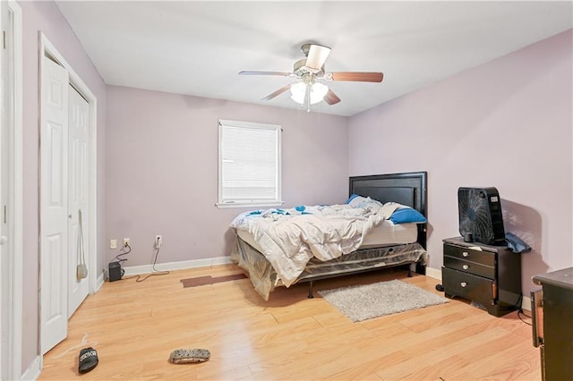 bedroom featuring hardwood / wood-style floors, ceiling fan, and a closet