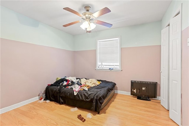 bedroom with ceiling fan and light hardwood / wood-style floors