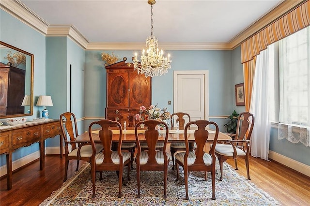 dining room with crown molding, a chandelier, and hardwood / wood-style flooring