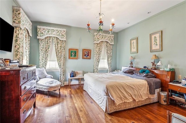 bedroom with light wood-type flooring, crown molding, and an inviting chandelier