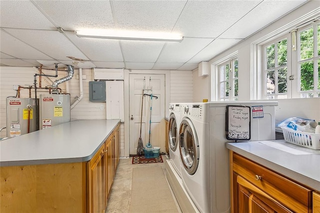 washroom with cabinets, electric panel, wooden walls, and water heater