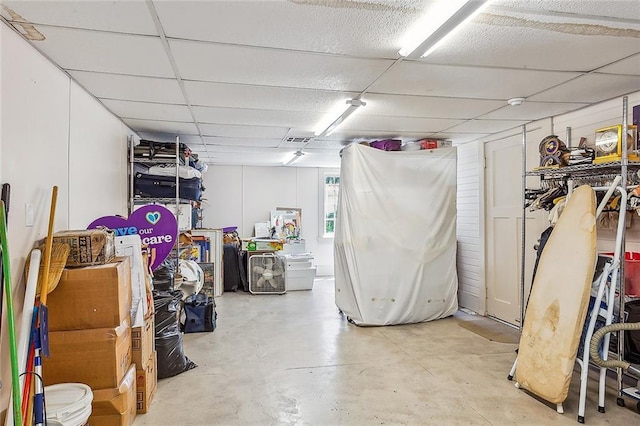 basement with a paneled ceiling