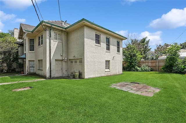 back of property featuring a lawn