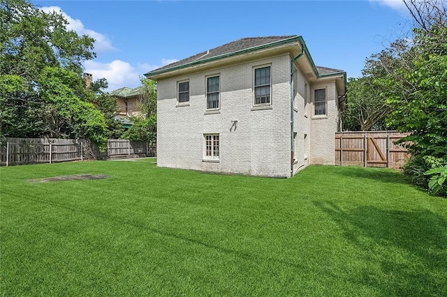 rear view of house with a lawn