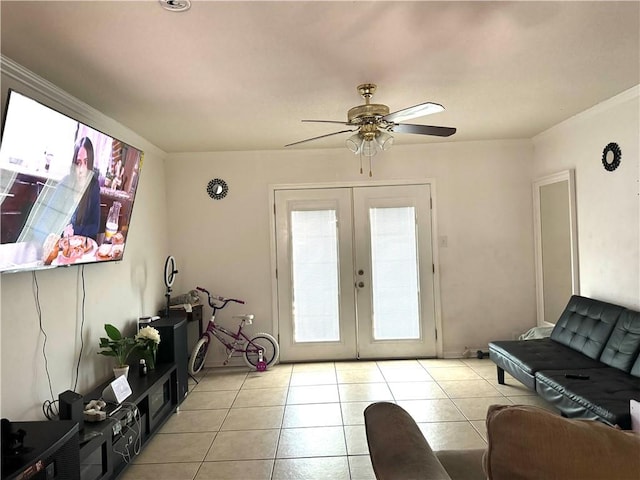 tiled living room featuring ceiling fan and french doors