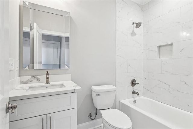 full bathroom featuring tiled shower / bath combo, toilet, and vanity