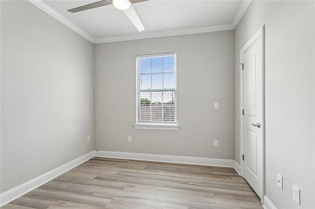 empty room featuring ceiling fan, light wood-type flooring, and crown molding