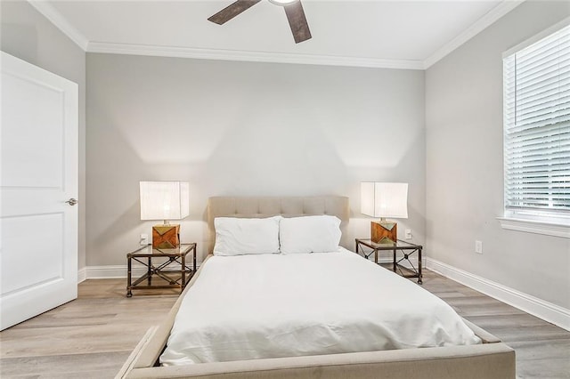 bedroom with multiple windows, ornamental molding, and hardwood / wood-style floors