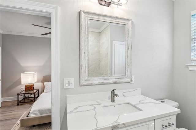 bathroom with vanity, crown molding, hardwood / wood-style floors, and ceiling fan