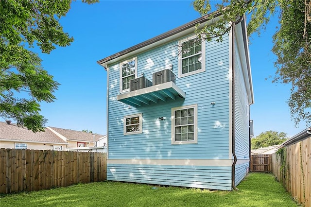 rear view of property with a lawn