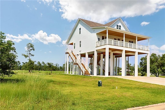 beach home featuring a carport and a front yard