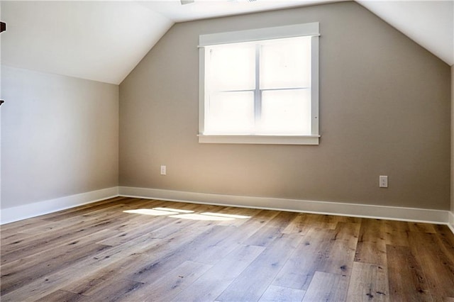 bonus room featuring vaulted ceiling and hardwood / wood-style floors