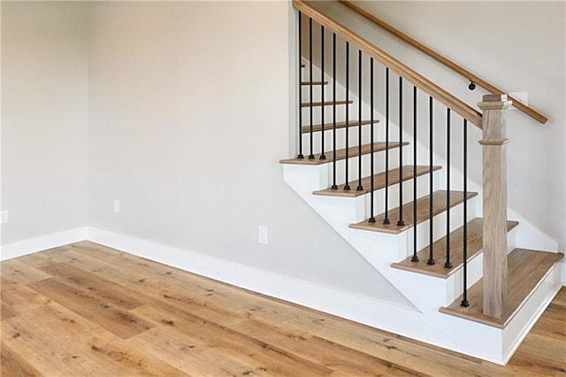 staircase with hardwood / wood-style floors