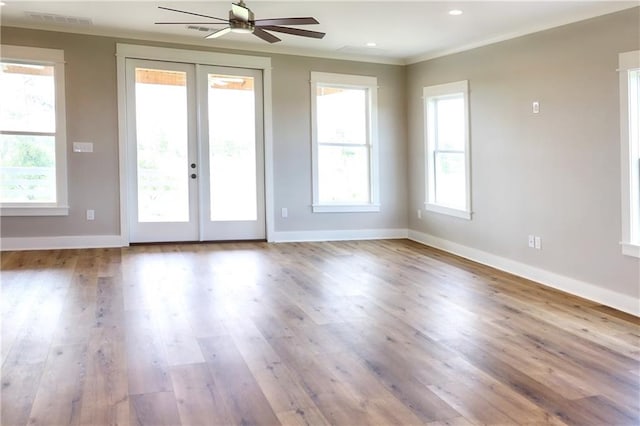 interior space featuring crown molding, wood-type flooring, french doors, and ceiling fan