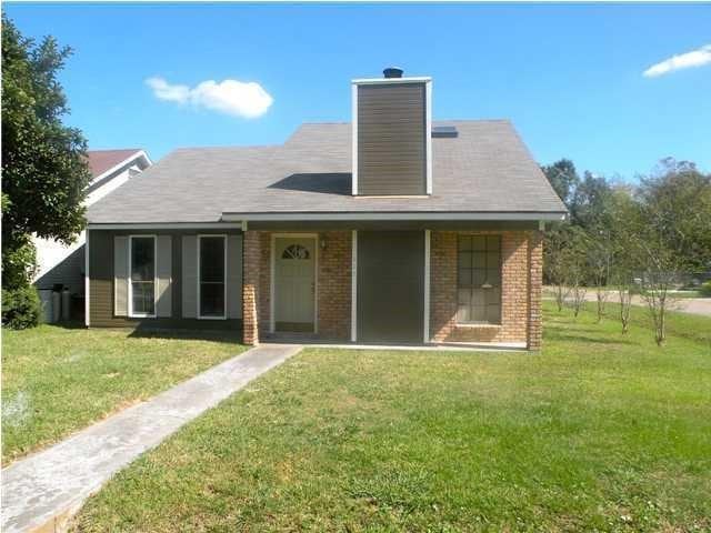 rear view of property featuring a yard