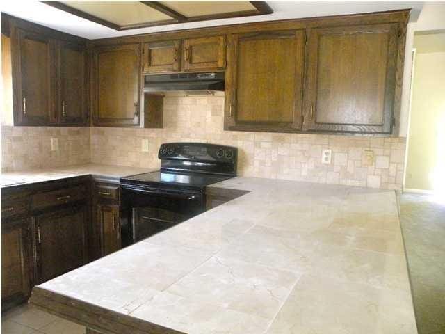 kitchen featuring black range with electric cooktop and tasteful backsplash