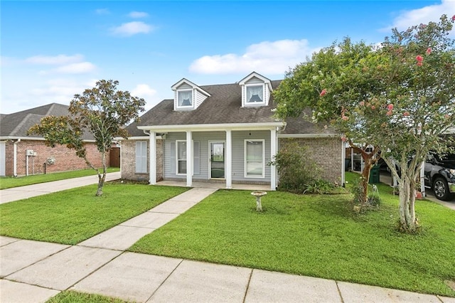 new england style home featuring covered porch and a front lawn