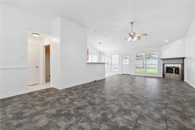 unfurnished living room featuring a tiled fireplace, dark tile patterned flooring, ceiling fan, and lofted ceiling