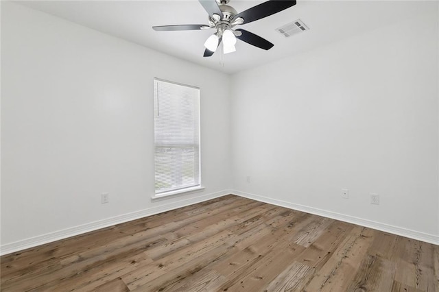 spare room with ceiling fan and wood-type flooring