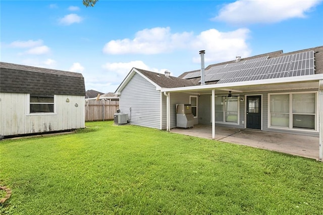 exterior space featuring a yard, central AC, solar panels, a patio area, and ceiling fan