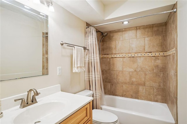 full bath featuring shower / bath combo with shower curtain, vanity, and toilet