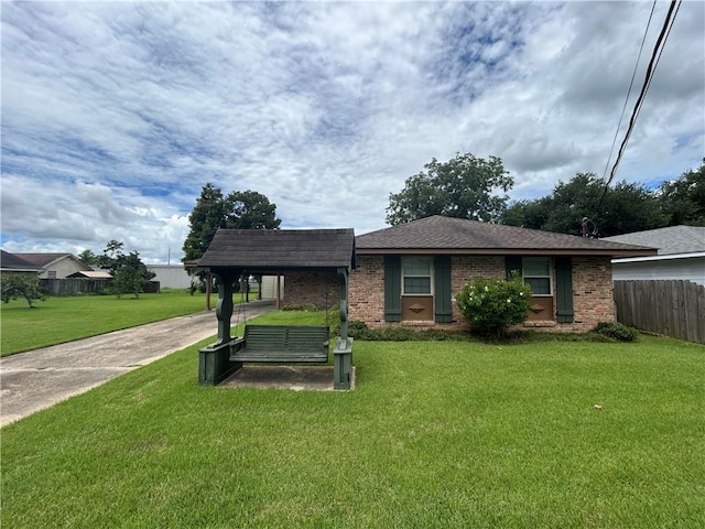 view of front of home with a carport and a front lawn