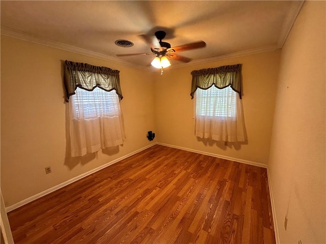 spare room with ceiling fan, plenty of natural light, ornamental molding, and hardwood / wood-style flooring