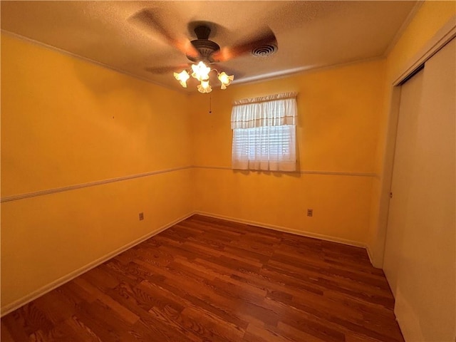 unfurnished room with a textured ceiling, hardwood / wood-style flooring, ceiling fan, and crown molding