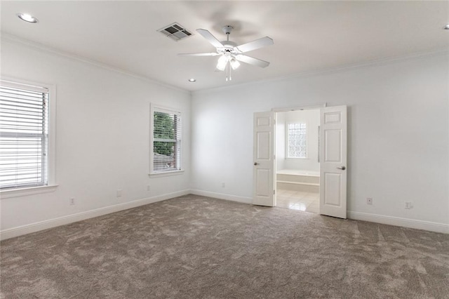 carpeted empty room with crown molding and ceiling fan