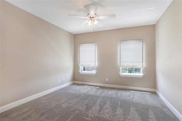 empty room featuring carpet flooring and ceiling fan