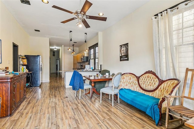 interior space with light wood-type flooring and ceiling fan