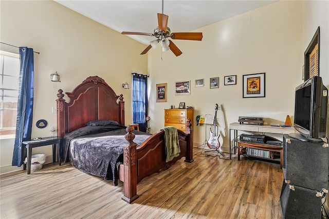 bedroom with wood-type flooring and ceiling fan