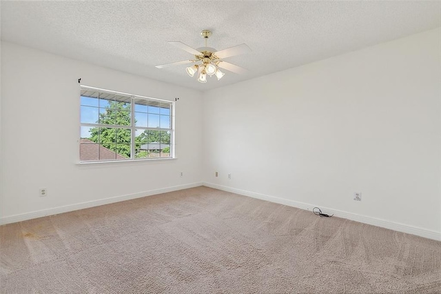 carpeted spare room featuring a textured ceiling and ceiling fan