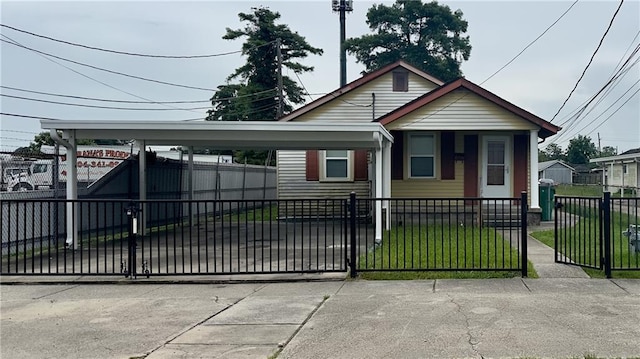 view of front of property with a carport and a front yard