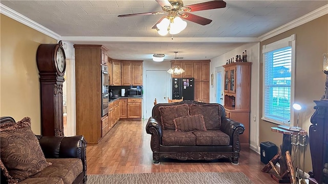 living room featuring light hardwood / wood-style floors, ceiling fan, and crown molding