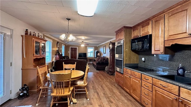 kitchen with light hardwood / wood-style floors, tasteful backsplash, hanging light fixtures, black appliances, and ceiling fan