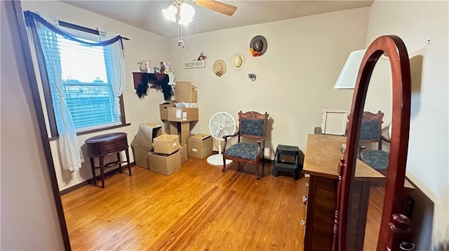 sitting room featuring ceiling fan and hardwood / wood-style flooring