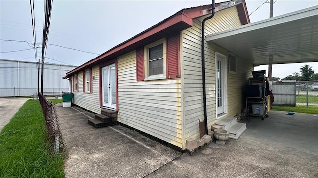 view of side of property featuring a carport