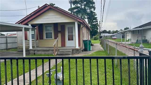 view of front of house featuring a front lawn and central air condition unit