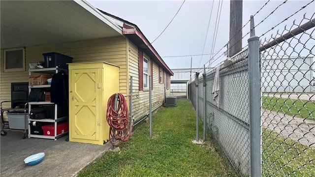 view of home's exterior featuring central air condition unit and a yard