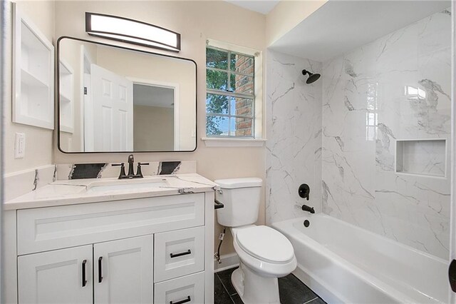 full bathroom featuring tiled shower / bath combo, vanity, toilet, and tile patterned flooring