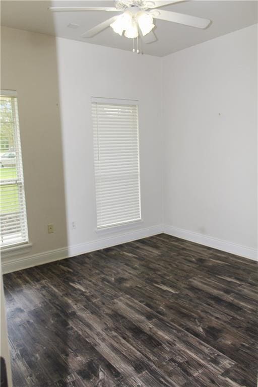 spare room featuring dark wood-type flooring and ceiling fan