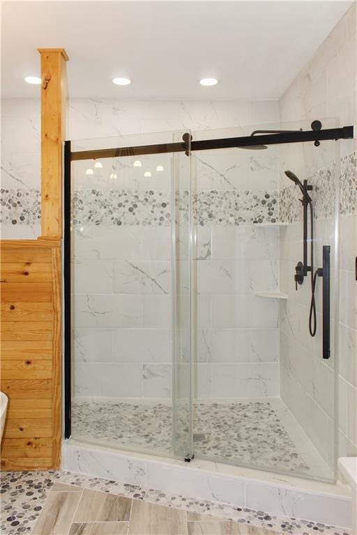 bathroom featuring a shower with shower door