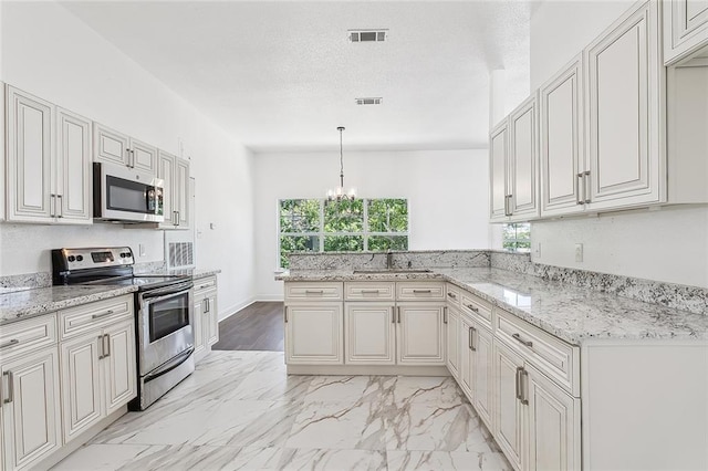 kitchen with pendant lighting, stainless steel appliances, sink, kitchen peninsula, and light stone counters