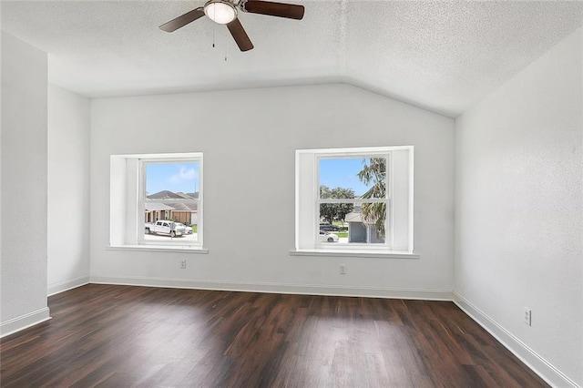 spare room with ceiling fan, a textured ceiling, dark hardwood / wood-style floors, and vaulted ceiling