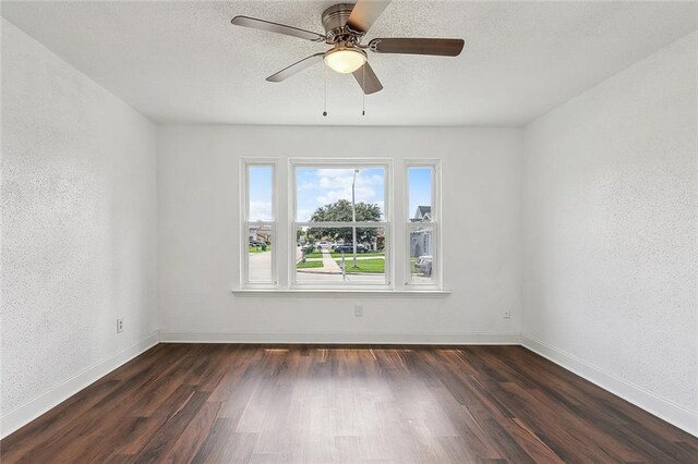 unfurnished room featuring ceiling fan and dark hardwood / wood-style floors