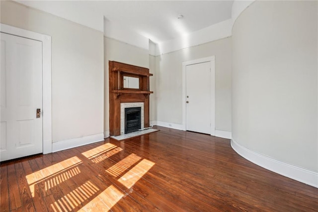 unfurnished living room with a fireplace and dark hardwood / wood-style floors