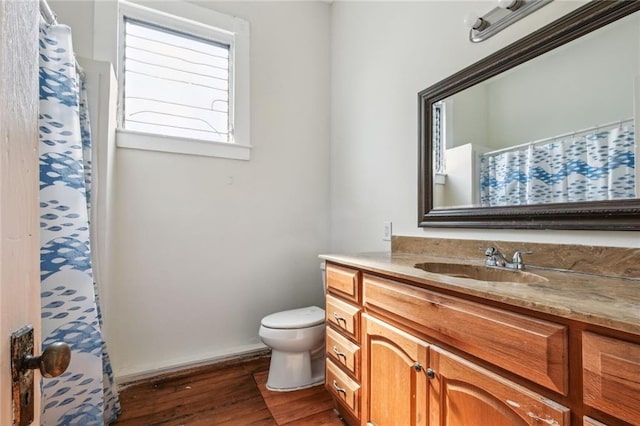 bathroom with vanity, toilet, and wood-type flooring