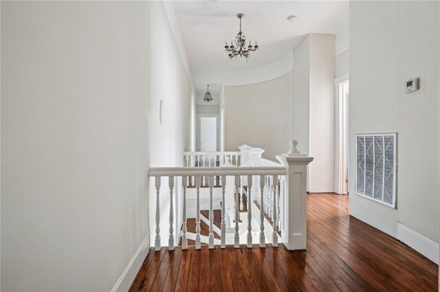 593739 Freret St, New Orleans, LA 70115 - corridor featuring an upstairs landing, a chandelier, dark wood-style floors, and plenty of natural light