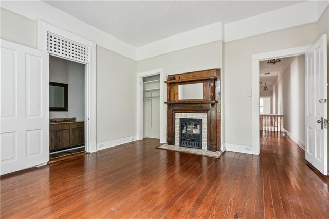 593739 Freret St, New Orleans, LA 70115 - unfurnished living room featuring wood finished floors and a fireplace